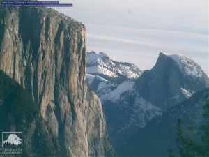 tall rocky mountain overlooking snow covered mountains, el capitan,half dome, Yosemite national park